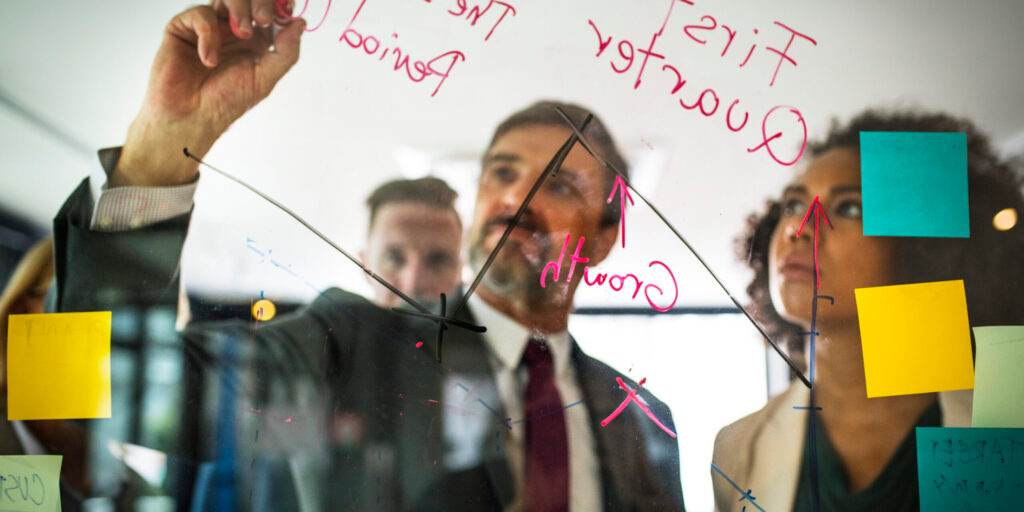 Business people planning on a glass wall