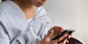 girl-checking-her-phone-before-school